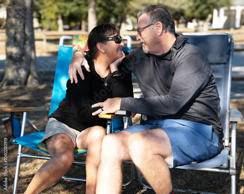 An elderly couple displaying affection outdoors.