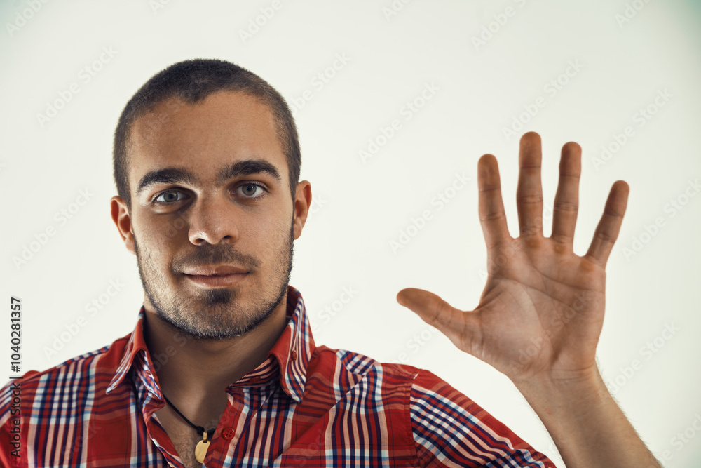 Naklejka premium Young man pointing to numbers and figures on a virtual screen