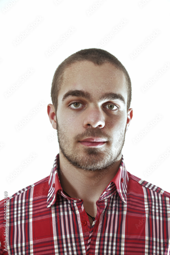 Fototapeta premium Young man with short hair and red shirt posing on white backgrou