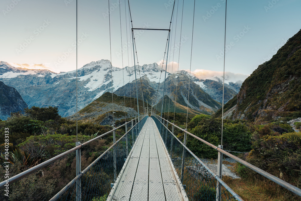 Obraz premium View of suspension bridge with mountain range on Hooker Valley Track in national park at New Zealand