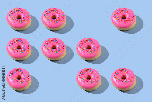 Vibrant pink donuts on blue background