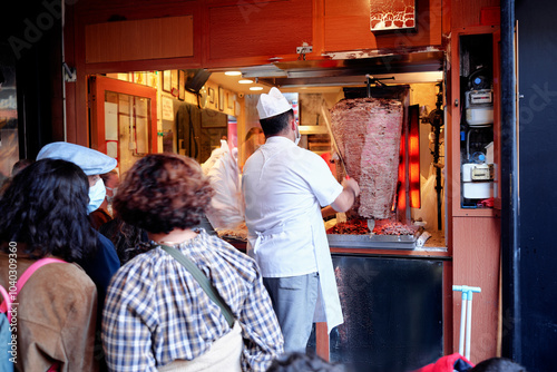 Photography Turkish Kebab donner meat cooking on large skewers in a take away sandwich shop
