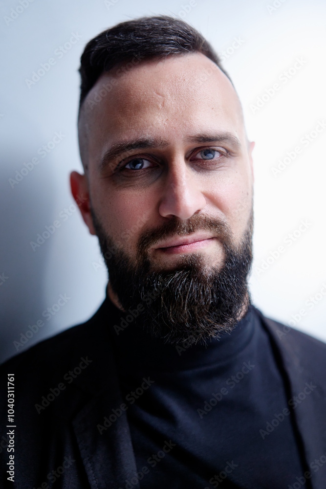 Studio portrait of young handsome man with beard. Studio portrait of young handsome man with beard.