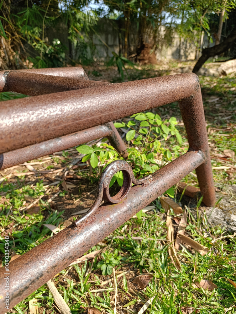 An old rusty iron pipe seesaw stand