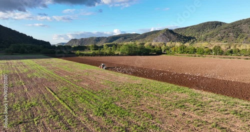 Tractor ploughing the land, at Namedy, Andernach, Germany along the rhine river. photo