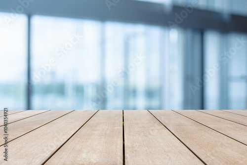 Empty wooden in front of blurred background of  the glass in the office building.
