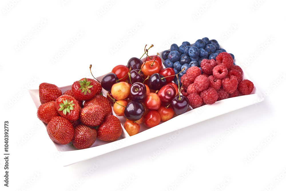 A variety of fresh berries and cherries arranged on a white plate, showcasing strawberries, cherries, blueberries, and raspberries, isolated on a white background.