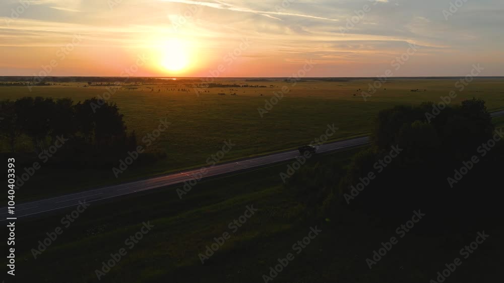 A truck and cars are driving along the highway at dawn