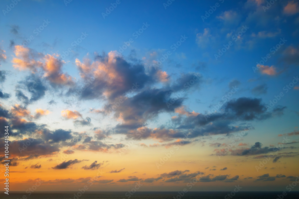 Majestic dusk in Atlantic Ocean. Sunset sky twilight in the evening with colorful sunlight. Abstract nature background. Dramatic orange and blue sky with dark and yellow clouds. Majestic dusk in Atlantic Ocean. Sunset sky twilight in the evening with colorful sunlight. Abstract nature background. Dramatic orange and blue sky with dark and yellow clouds.