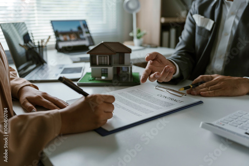 Fotografía Real estate concept with a real estate agent showing a client where to sign a co