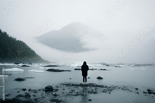 Valdez Glacier Lake with distance mountains in rain and mist, Valdez, Alaska, USA