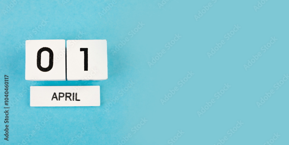 April 1, cube calendar on a blue background with copy space April 1, cube calendar on a blue background with copy space