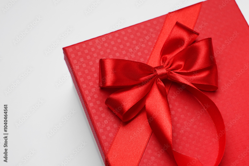 Gift box with bow on light grey background Gift box with bow on light grey background