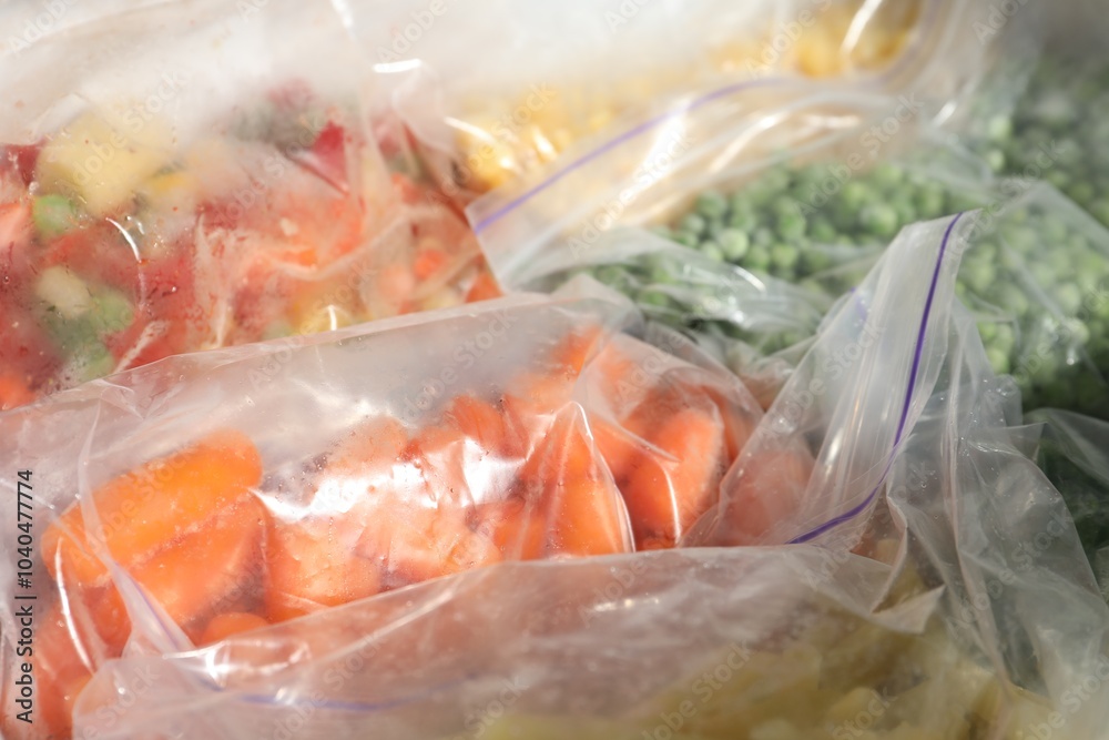Plastic bags with different frozen vegetables in refrigerator, closeup Plastic bags with different frozen vegetables in refrigerator, closeup