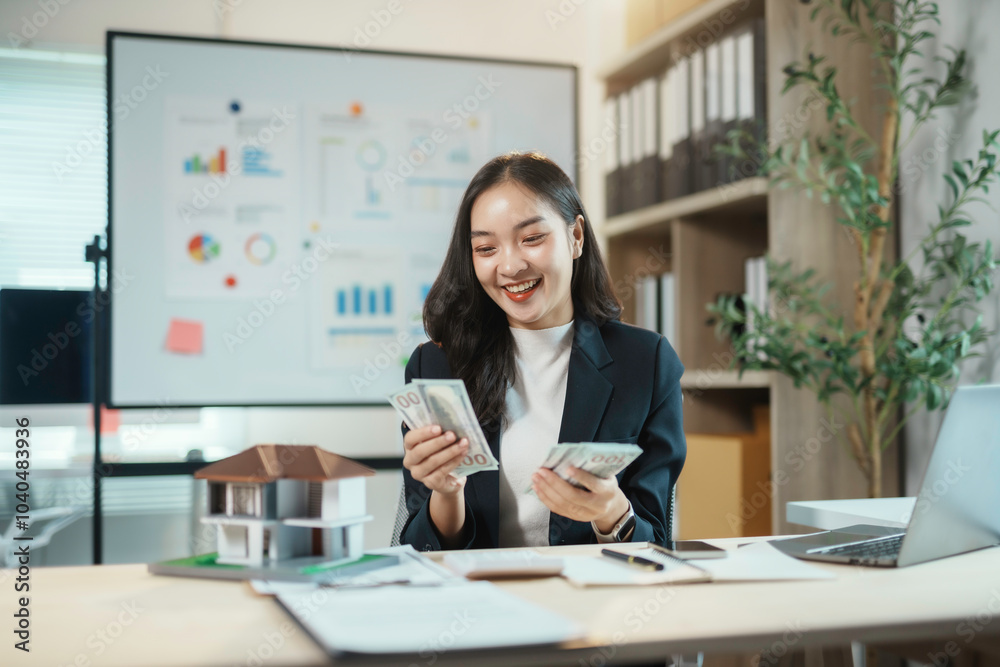 Smiling businesswoman counting american dollar banknotes after closing a deal in office Smiling businesswoman counting american dollar banknotes after closing a deal in office