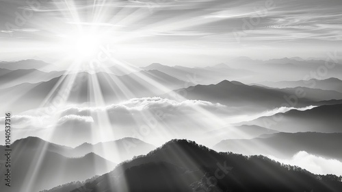 Breathtaking black and white mountain landscape with dramatic sun rays piercing through the clouds, creating a serene and majestic atmosphere.