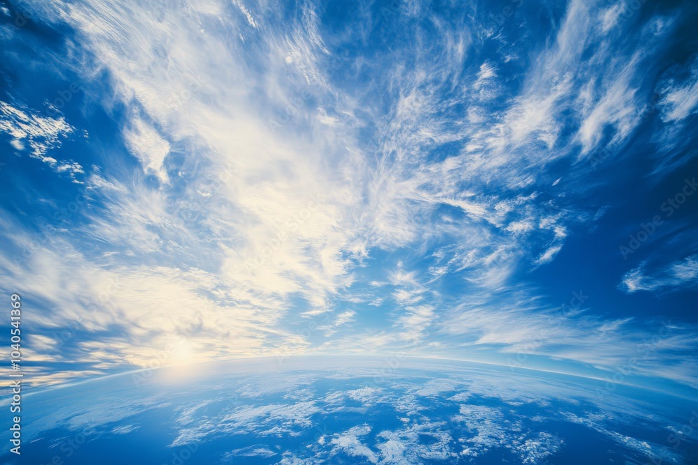 Wispy formations of clouds dance above the clear horizon of Earth, set against a backdrop of sky, offering a sense of freedom and expansive serenity. Wispy formations of clouds dance above the clear horizon of Earth, set against a backdrop of sky, offering a sense of freedom and expansive serenity.