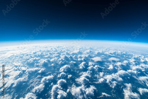 A mesmerizing sight of Earth’s horizon enveloped in clouds, set against a backdrop of deep blue sky, illustrating the planet’s unique atmospheric beauty. photo