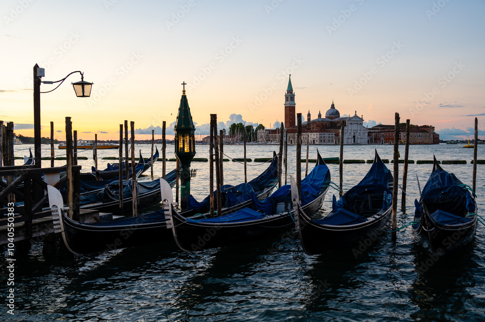 The island of San Giorgio Maggiore and traditional gondolas of Venice, Italy The island of San Giorgio Maggiore and traditional gondolas of Venice, Italy