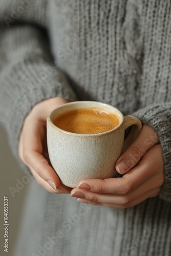 A cozy moment with a warm drink in a knitted sweater during a chilly day