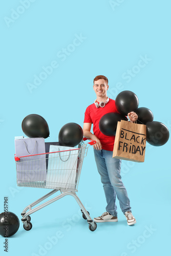 Young redhead man with bags...
