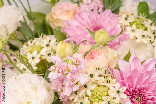 Bouquet of flowers with pink roses, chrysanthemum and freesia flower in a vase isolated on a white background.