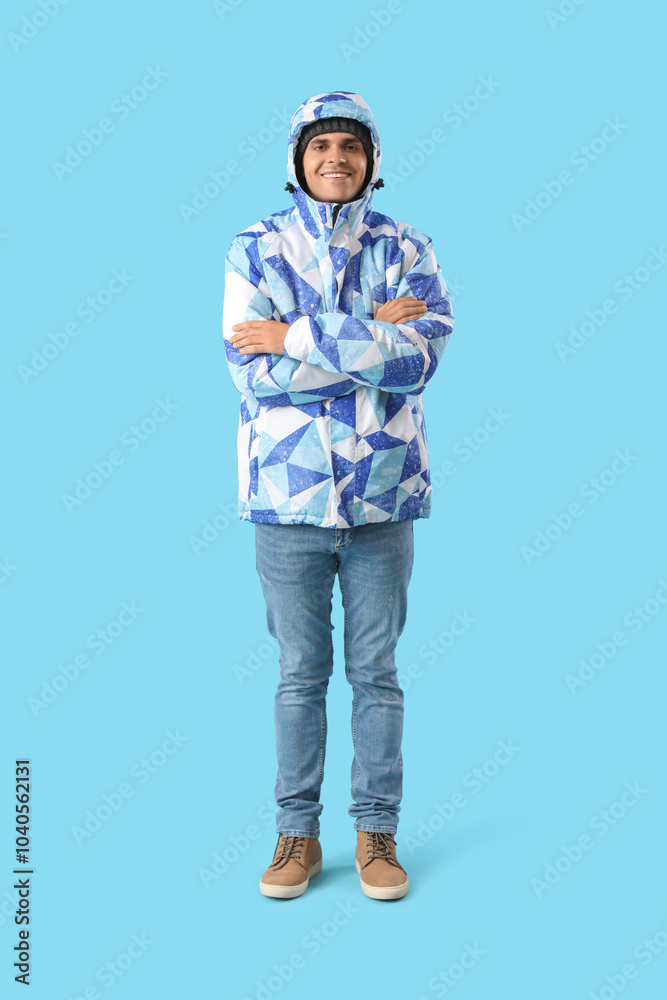 Frozen young man in winter clothes on color background Frozen young man in winter clothes on color background
