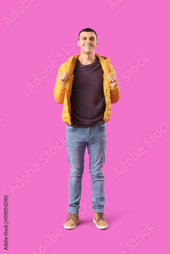 Smiling young man in yellow...