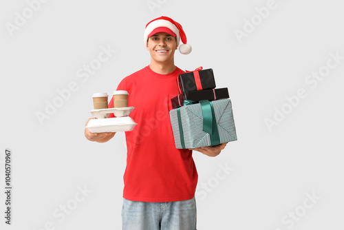 Delivery man in Santa hat w...