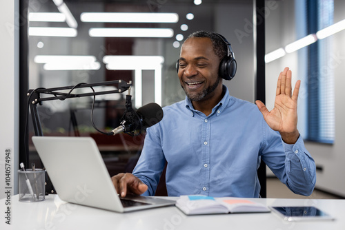 Photography Mature businessman wearing headphones conducting virtual meeting using laptop and microphone