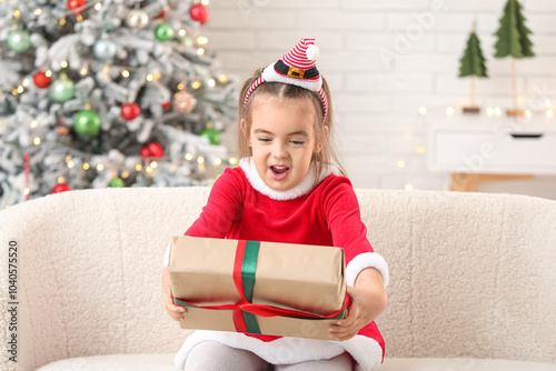 Excited young girl in santa...