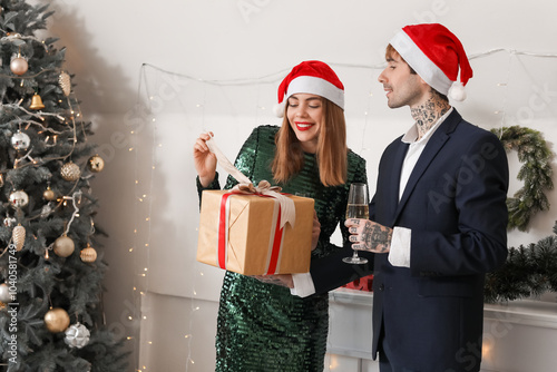 Young couple in Santa hats ...