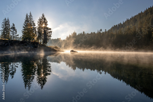 Lake Cauma near Laax-Flims-Waldhaus in Switzerland in summer with reflections in the crystal-clear water in the morning before sunrise photo