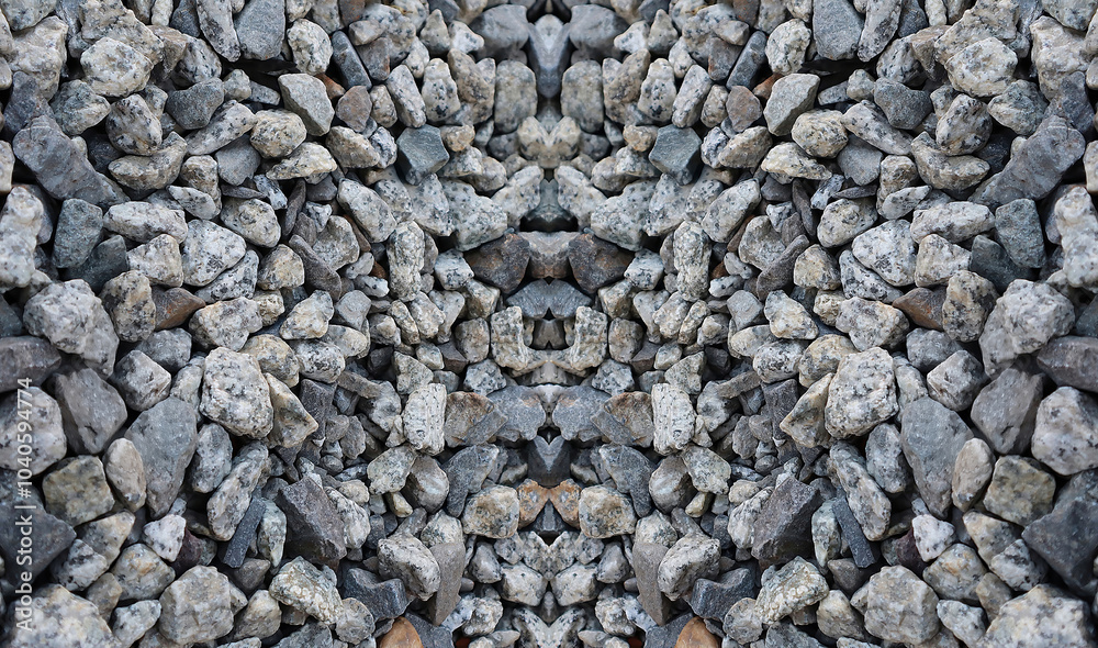 Close-up of a textured rock pattern with gray and white stones. A symmetrical arrangement of rough stones creating a natural mosaic. Natural stone texture with a unique mirrored pattern. Close-up of a textured rock pattern with gray and white stones. A symmetrical arrangement of rough stones creating a natural mosaic. Natural stone texture with a unique mirrored pattern.