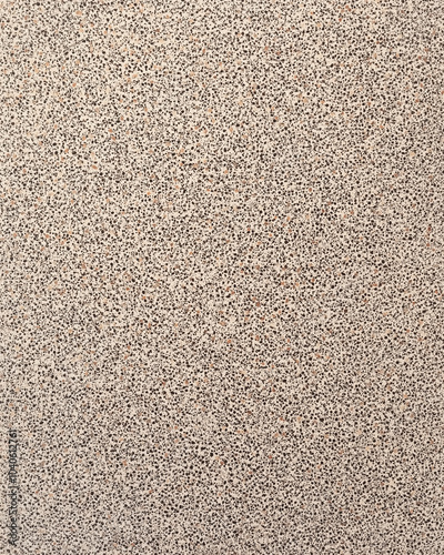 Rough Sandpaper: A sheet of coarse sandpaper, with a gritty surface composed of small, rough particles.