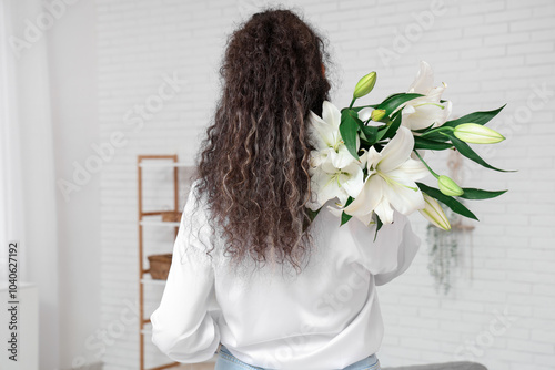 Woman with curly hair holdi...