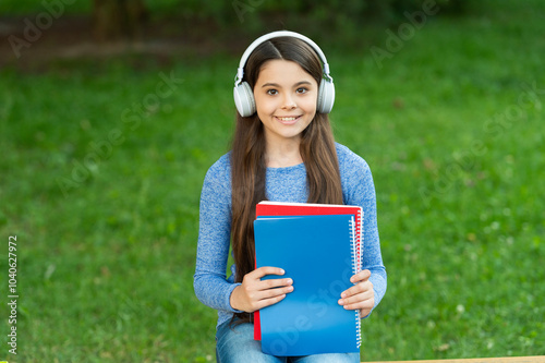 Teen girl in wireless headphones. Student listen audiobook. Homework education. Back to school. Student teen girl listen audiobook. School education for girl. Student lifestyle. School education