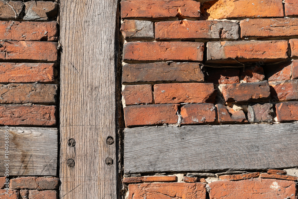 Weathered brick wall with wooden beams in rustic architecture