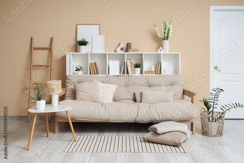 Cozy sofa, shelving unit and coffee table in interior of living room