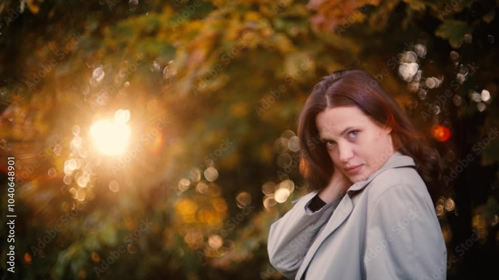 woman in autumn coat enjoying autumn landscape in forest, yellow leaves on trees woman in autumn coat enjoying autumn landscape in forest, yellow leaves on trees