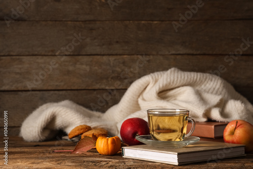 Εκτύπωση καμβά Composition with cup of green tea, notebook and sweater on table near wooden wal