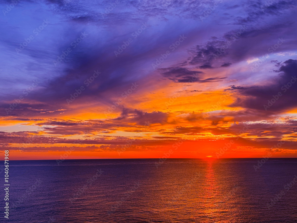 Colorful sunset sky over dark ocean at night. Colorful sunset sky over dark ocean at night.