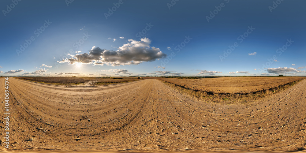 Obraz premium hdri 360 panorama on gravel road among fields in nasty evening before storm and sunset in equirectangular full seamless spherical projection, for VR AR virtual reality content