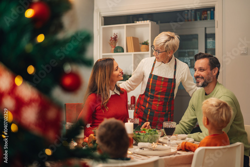 Happy family enjoying christmas dinner together at home photo