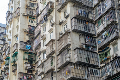Canvas Print A densely populated residential building in Macau, China with an older and weath