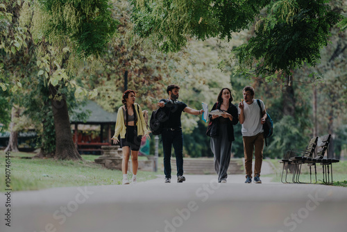 A group of students and a professor take a casual ice cream break, strolling through a scenic park. The scene captures a relaxed and friendly atmosphere after classes.