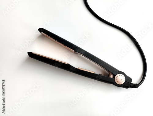 Black hair straightener isolated on white background 
