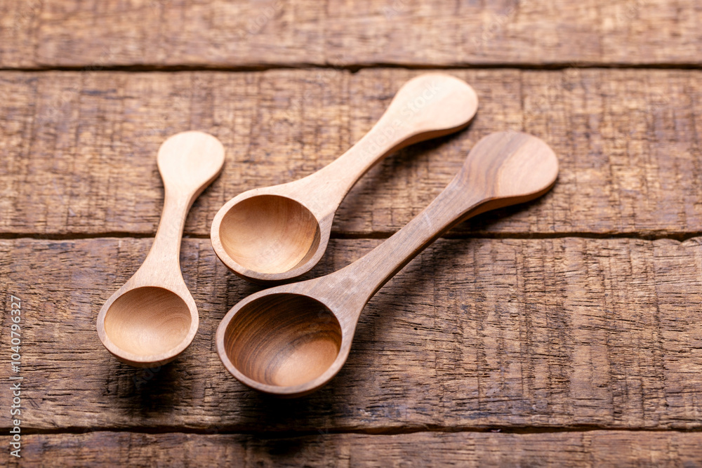 Three Wooden Spoons on Rustic Wooden Table Three Wooden Spoons on Rustic Wooden Table