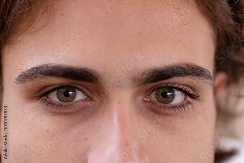 Close-up of man's green eyes gazing intently, capturing deep emotion and focus photo