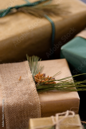 Rustic Christmas gifts wrapped with burlap and pine sprigs, creating festive charm, at home photo